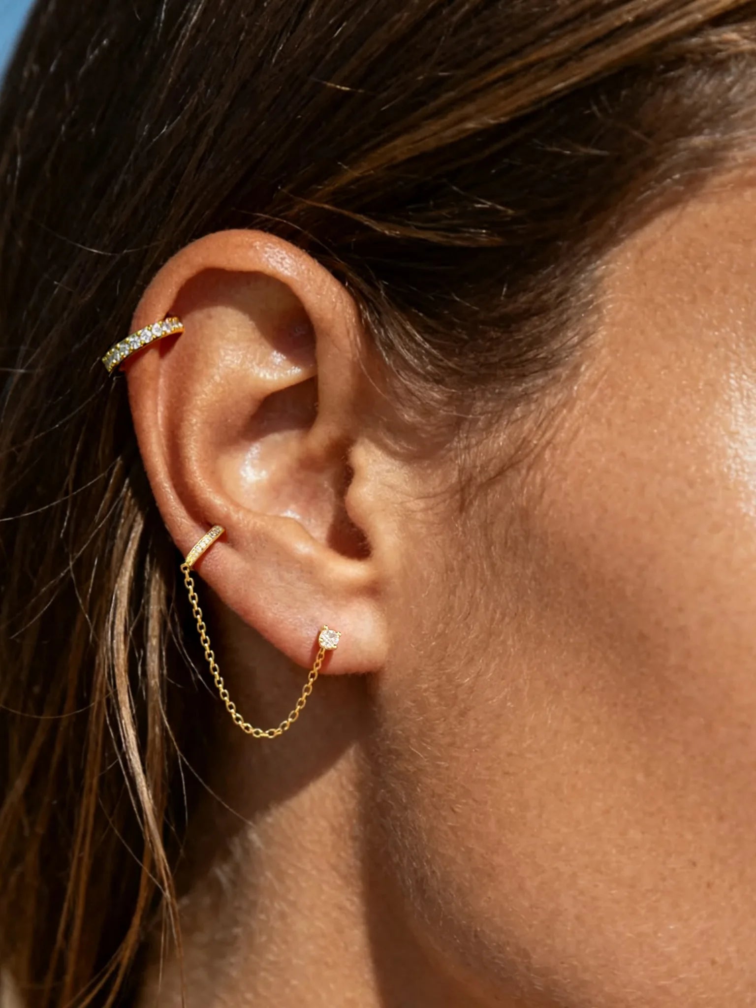 This innovative ear thread combines a sparkling cz stud for your lobe with a graceful chain that leads to a secure clip for your upper ear